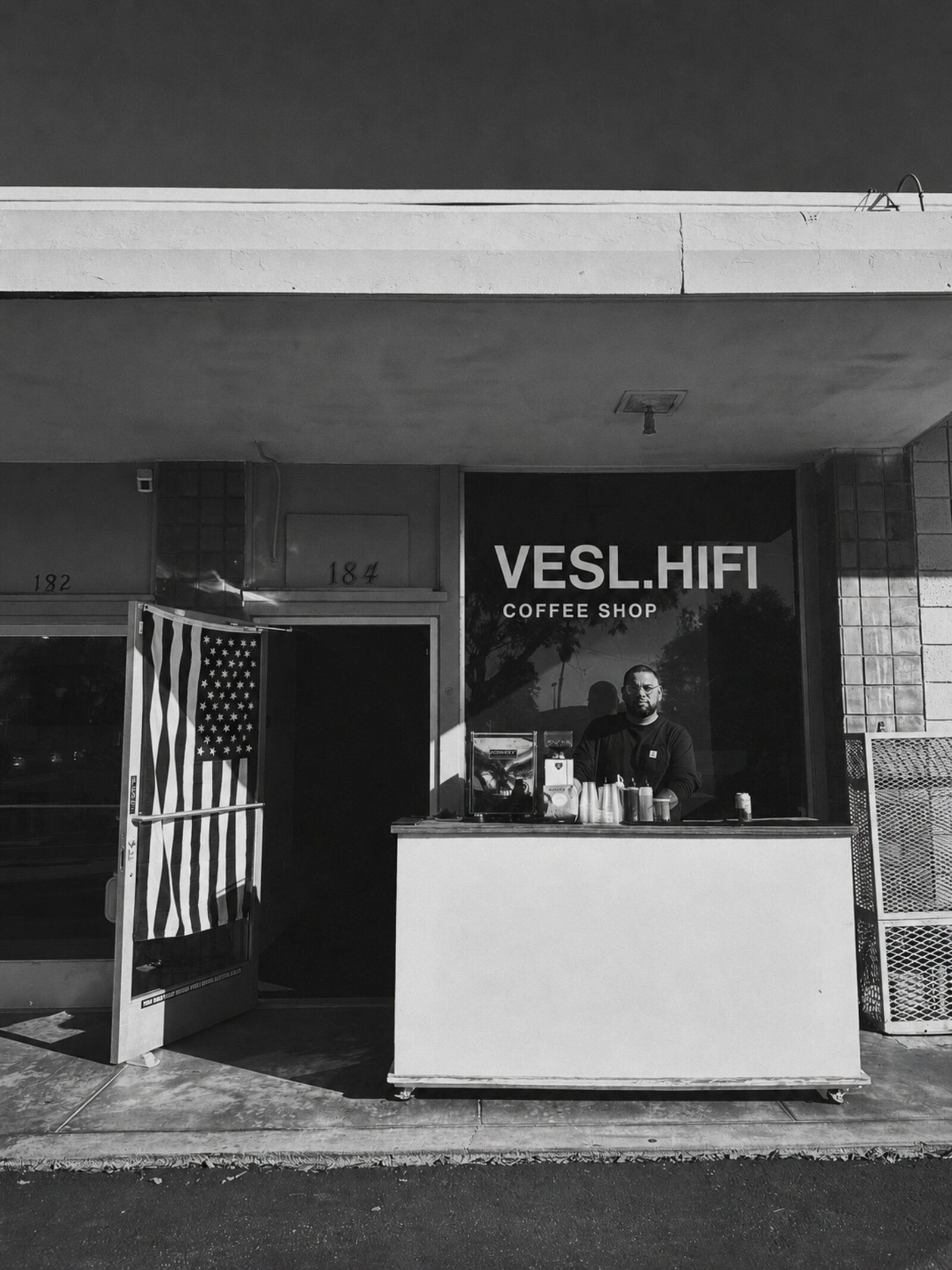 The VESL.HIFI mobile coffee cart set up in front of the shop on Main Street